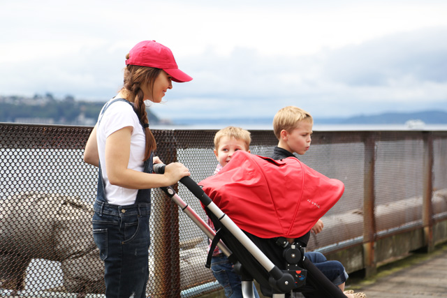red cap, red stroller, overalls