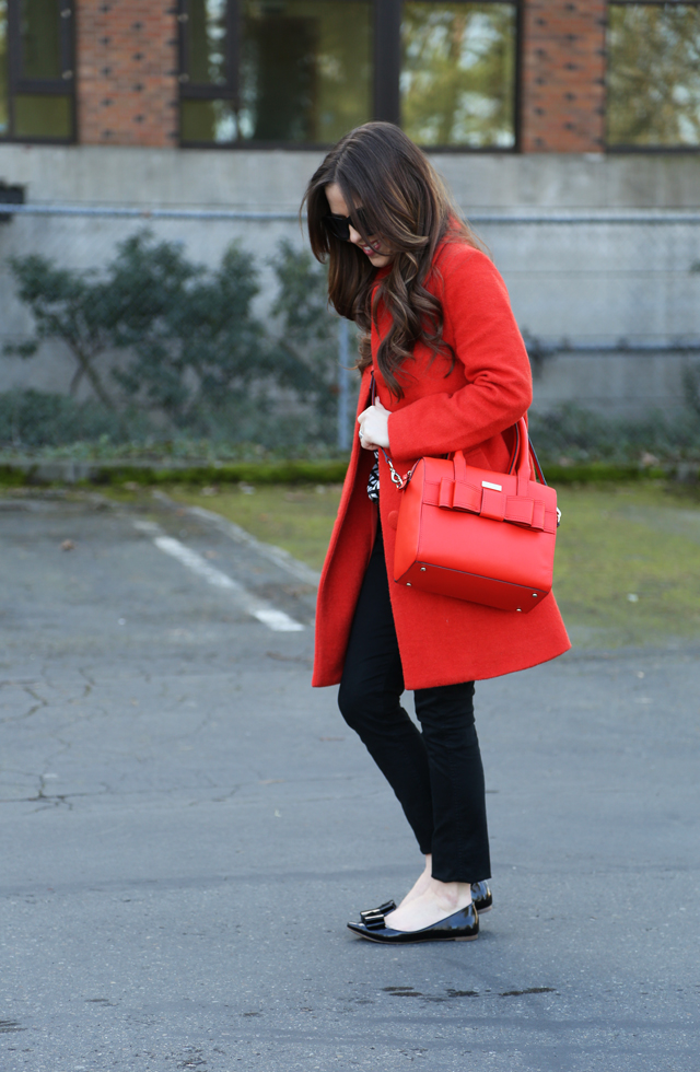 orange-red coat and matching bag