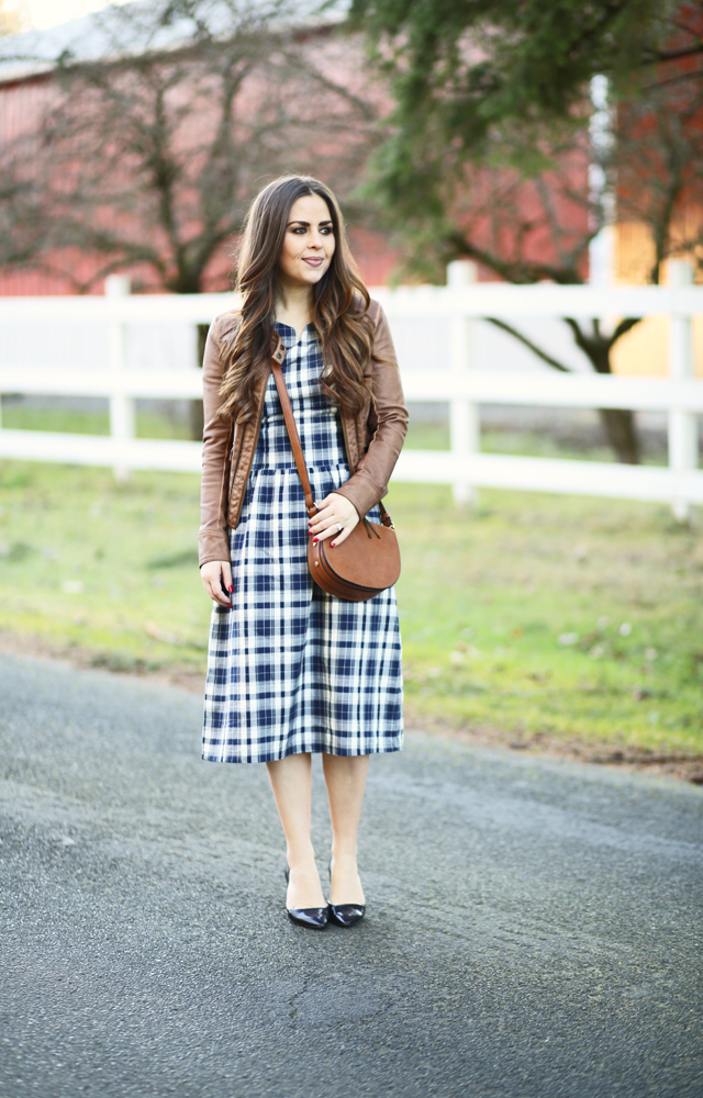 navy plaid paired with cognac leather jacket and saddle bag