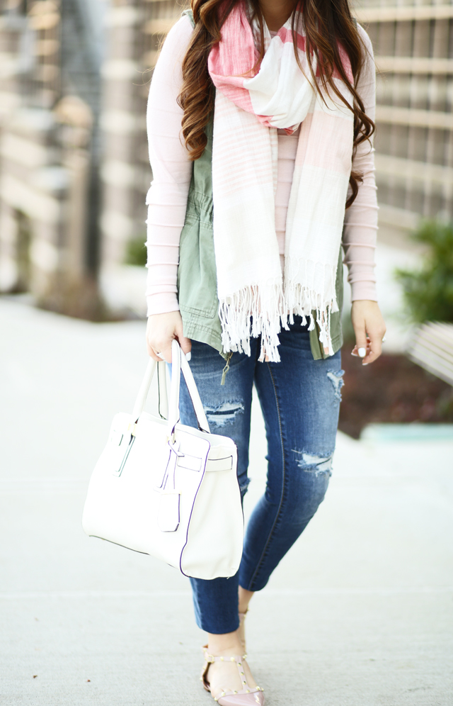 pink sweater with green army vest distressed denim