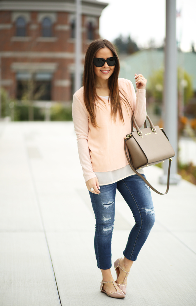 pink top with taupe bag ripped jeans